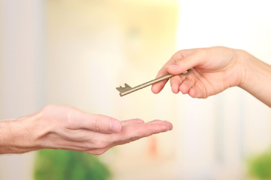 21856152 - transfer of house key, on bright background